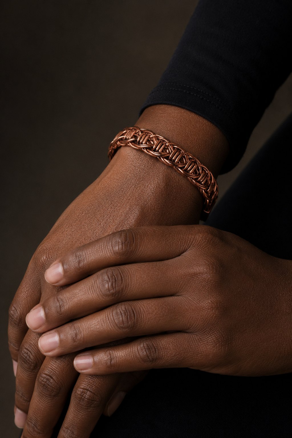 Hand-plaited copper cuff worn at the wrist